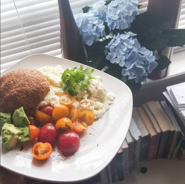 vegetarian breakfast with bread, eggs, tomatoes and avacados in house